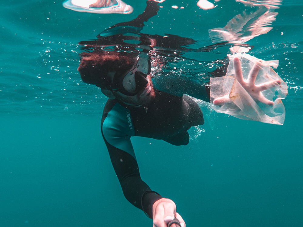Scuba diver holding a plastic bag