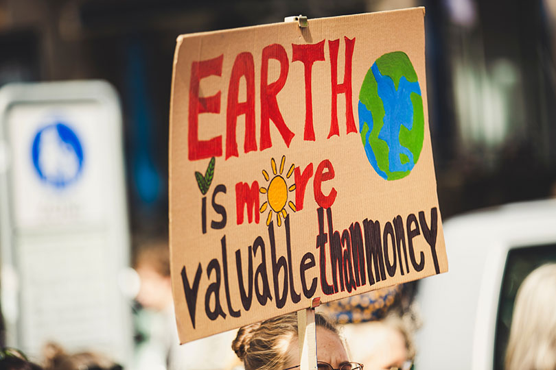Signage saying earth is more valuable than money