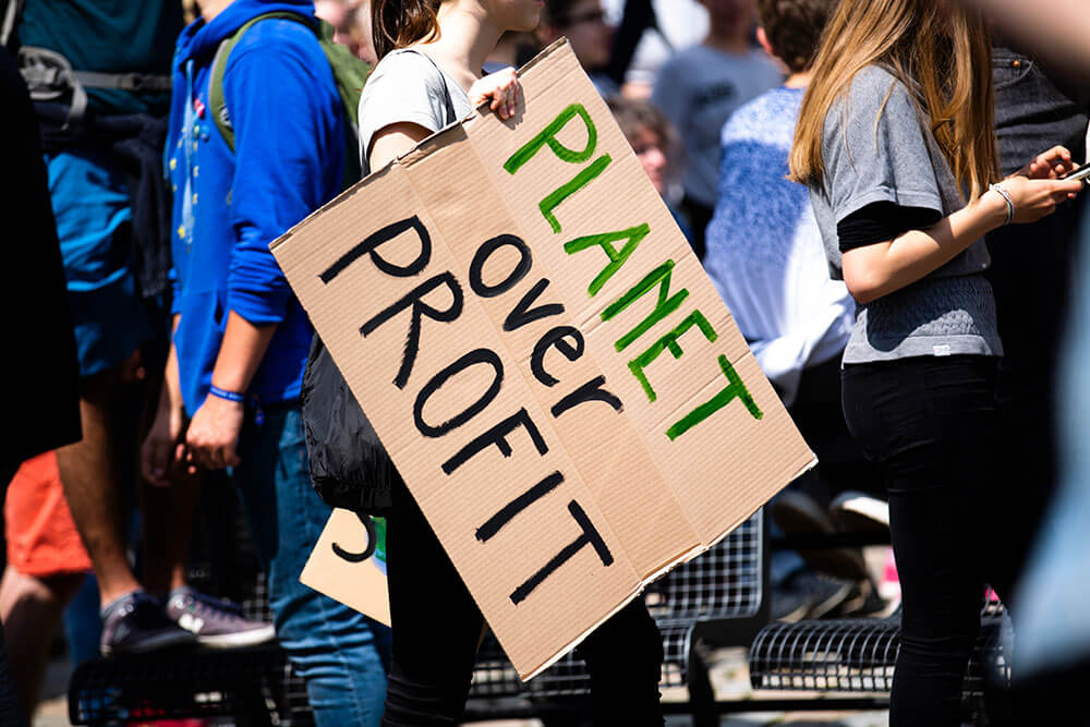 A woman holding a placard during a global climate strike